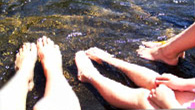 Picture of people soaking their feet in Hunsburger Lake at Spirit Point
